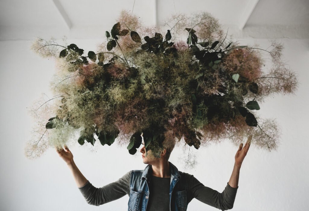 large decorative bouquet made of green leaves and moss hangs ove