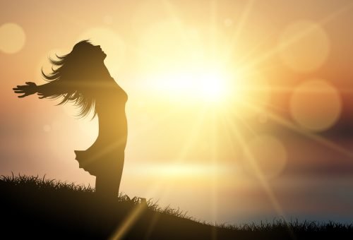 happy female against a sunset landscape